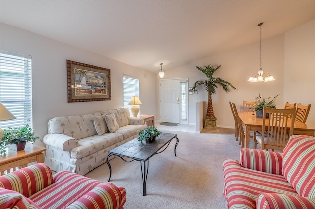 living room featuring light colored carpet, vaulted ceiling, and an inviting chandelier