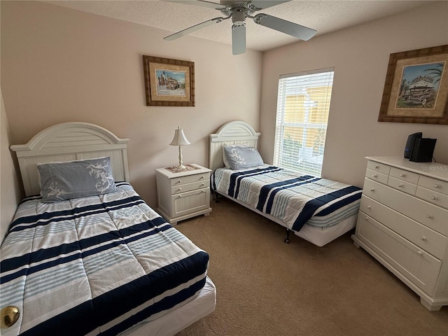 carpeted bedroom with a textured ceiling and ceiling fan