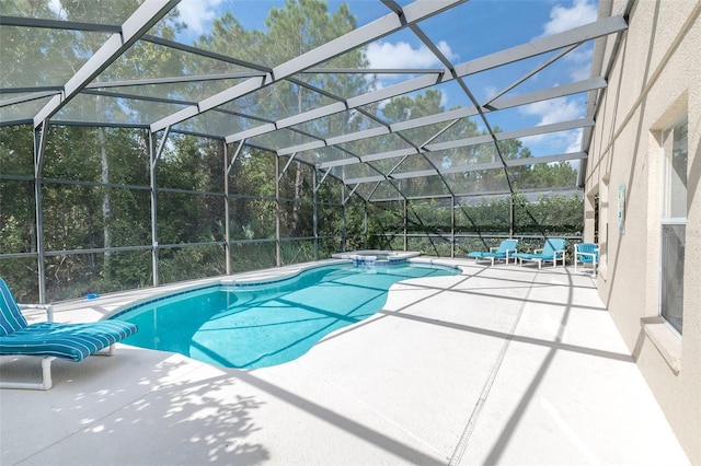 view of pool featuring glass enclosure and a patio area