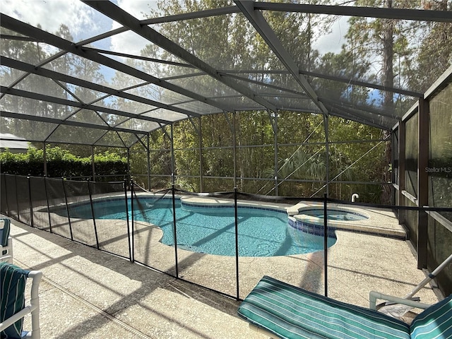 view of pool featuring a lanai, a patio, and an in ground hot tub