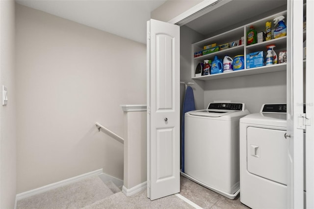 clothes washing area with independent washer and dryer and light colored carpet