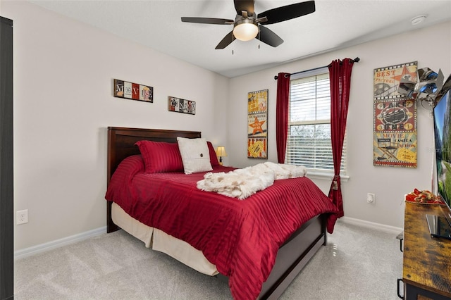 bedroom with ceiling fan and light colored carpet