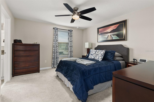 bedroom featuring ceiling fan and light carpet