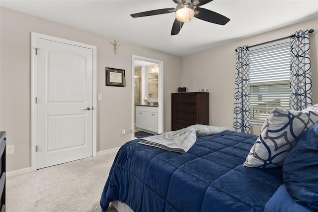 bedroom with carpet flooring, ensuite bathroom, and ceiling fan