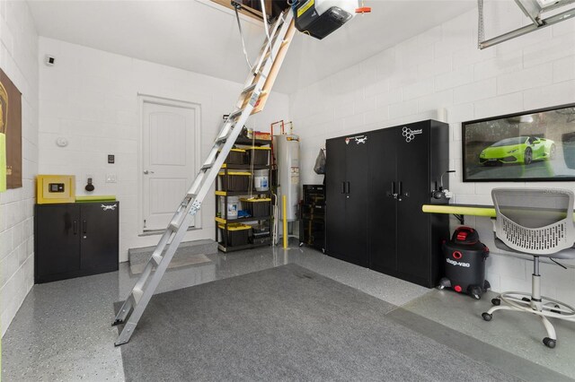 garage with a garage door opener and water heater