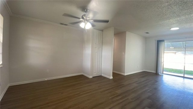 empty room featuring a textured ceiling, ceiling fan, dark hardwood / wood-style floors, and ornamental molding