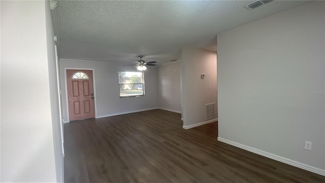 foyer featuring a textured ceiling, ceiling fan, and dark wood-type flooring