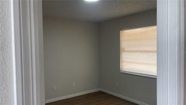 unfurnished room featuring dark hardwood / wood-style flooring