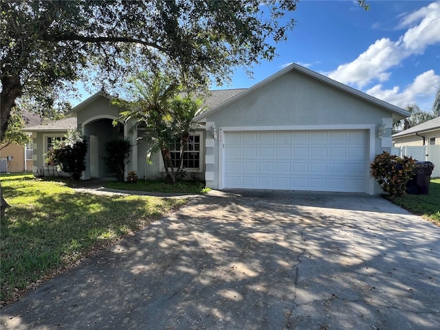 ranch-style house featuring a garage and a front yard