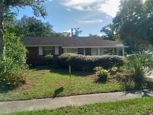 ranch-style home with a front lawn