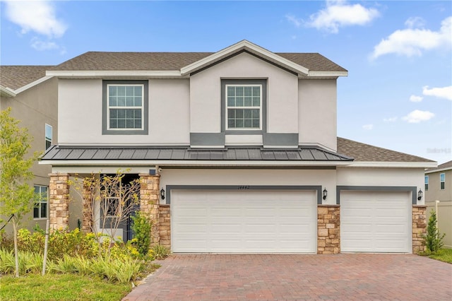 14442 Noto Ave, Clermont, FL 34714 - view of front of house with stone siding, a standing seam roof, stucco siding, a metal roof, and decorative driveway