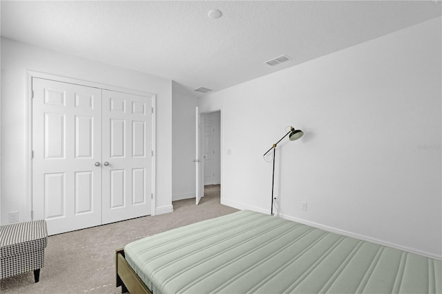 14442 Noto Ave, Clermont, FL 34714 - bedroom featuring carpet floors, a closet, and a textured ceiling