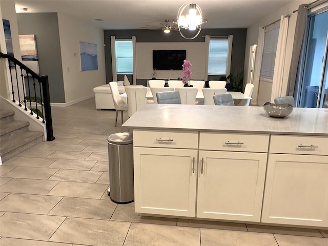 kitchen featuring white cabinetry, plenty of natural light, ceiling fan, and hanging light fixtures