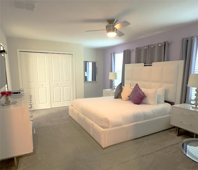 carpeted bedroom with a closet and ceiling fan