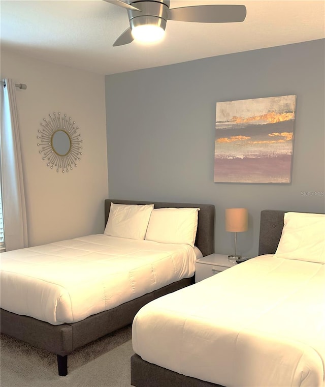 bedroom featuring ceiling fan and carpet