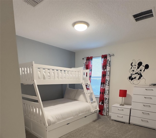 carpeted bedroom with a textured ceiling