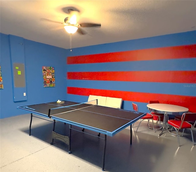 game room with a textured ceiling, concrete floors, and ceiling fan