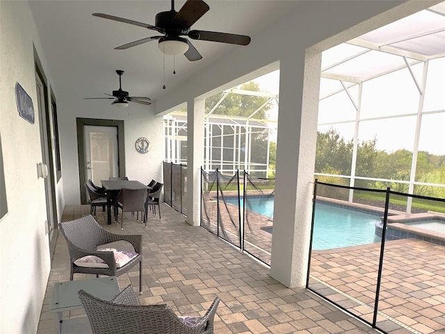 sunroom / solarium with ceiling fan and a pool