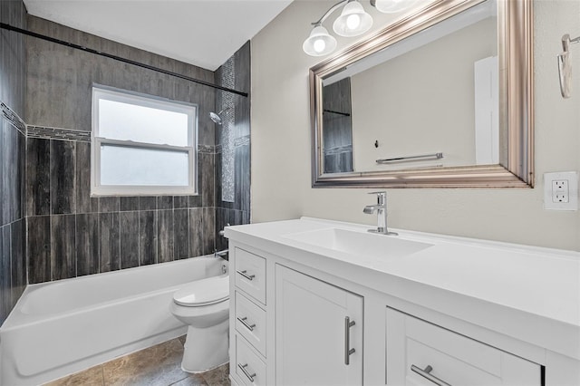 full bathroom featuring tile patterned flooring, tiled shower / bath, toilet, and vanity