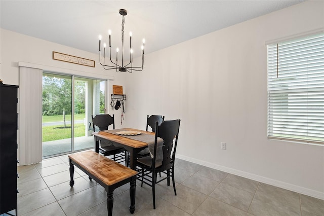 dining space featuring a notable chandelier and light tile patterned floors