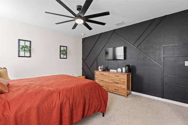 bedroom with ceiling fan, a textured ceiling, and light colored carpet