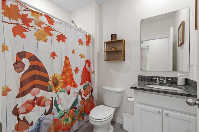 bathroom featuring walk in shower, vanity, and toilet