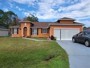 view of front facade featuring a front lawn and a garage