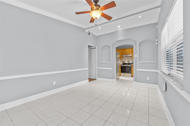 unfurnished living room featuring a wealth of natural light, ceiling fan, and crown molding