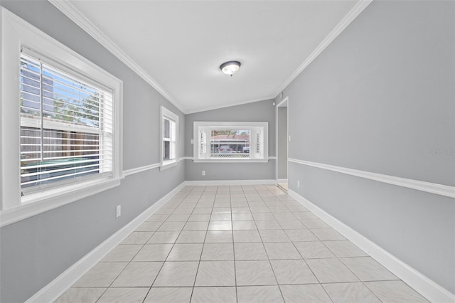 spare room featuring crown molding, light tile patterned floors, and vaulted ceiling