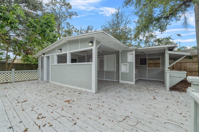 exterior space featuring a wooden deck and a sunroom