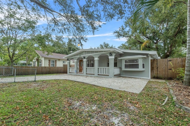 ranch-style house featuring a porch and a front yard