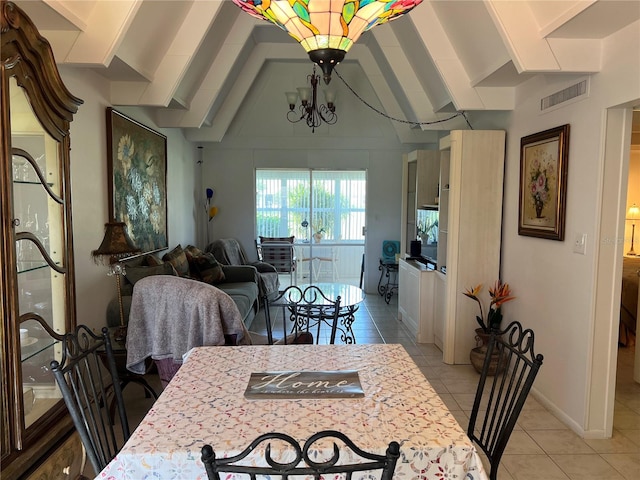 dining space with light tile patterned floors, vaulted ceiling, and a notable chandelier