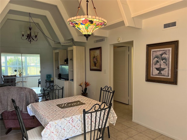 dining area with light tile patterned flooring, a notable chandelier, and vaulted ceiling with beams