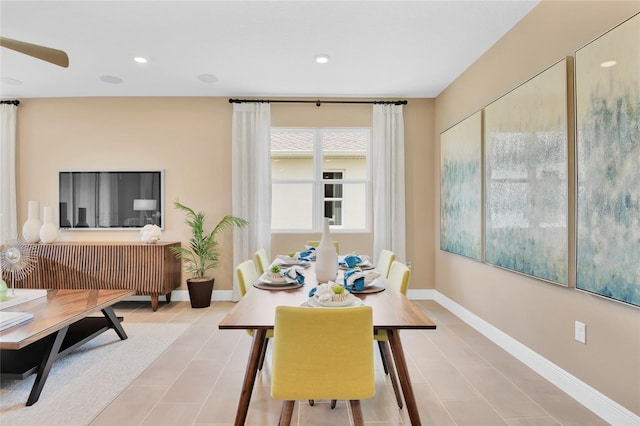 tiled dining area featuring ceiling fan