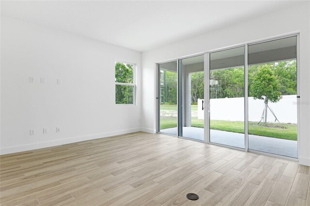 4060 Bannock Ave, Tavares, FL 32778 - unfurnished room featuring light wood-style floors and baseboards