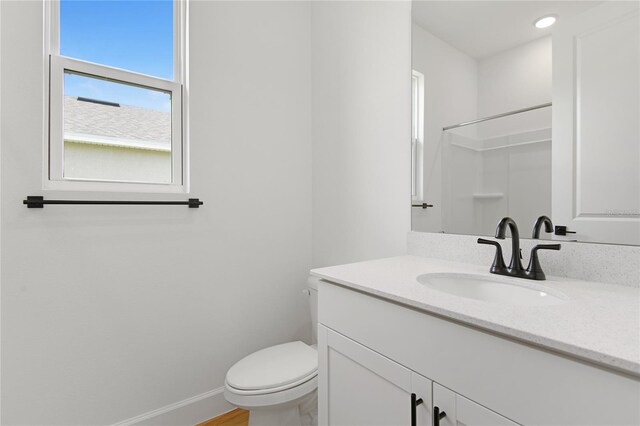 4060 Bannock Ave, Tavares, FL 32778 - bathroom with toilet, vanity, baseboards, a shower, and recessed lighting