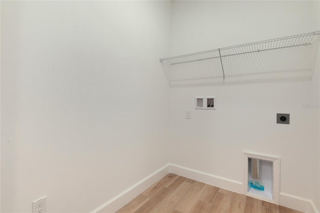 4060 Bannock Ave, Tavares, FL 32778 - laundry area featuring hookup for an electric dryer, washer hookup, light wood-style floors, and baseboards