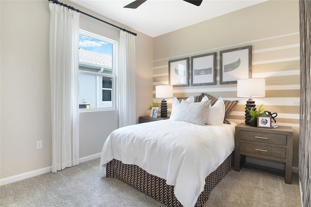 carpeted bedroom with ceiling fan and baseboards