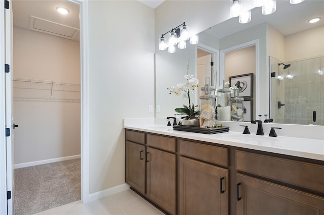 full bath with a shower stall, a walk in closet, double vanity, tile patterned flooring, and recessed lighting