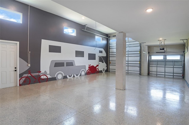 garage with recessed lighting and a garage door opener