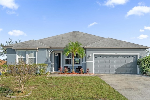 single story home with a garage and a front lawn