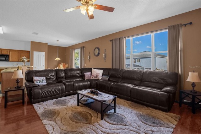 living room featuring dark hardwood / wood-style floors and ceiling fan