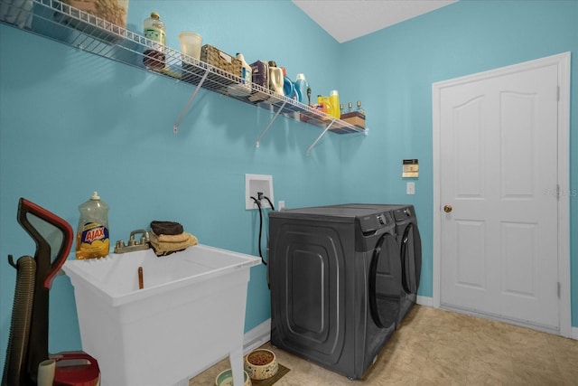 washroom featuring sink and washer and clothes dryer