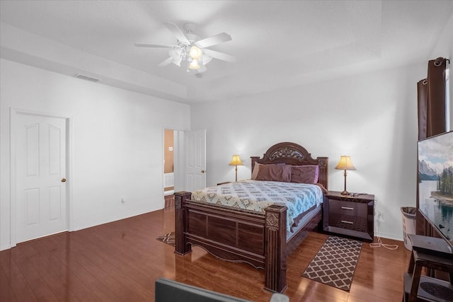 bedroom with dark hardwood / wood-style flooring and ceiling fan