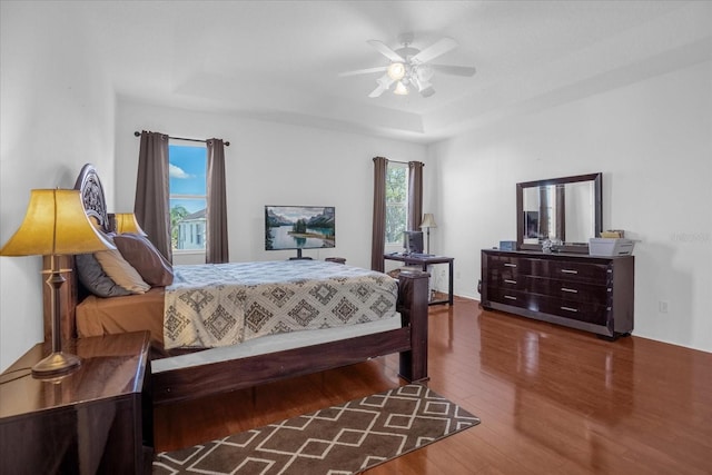 4523 Ashtubula Ct, Orlando, FL 32818 - bedroom featuring wood finished floors, a tray ceiling, and a ceiling fan