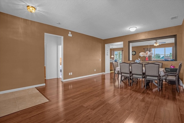 4523 Ashtubula Ct, Orlando, FL 32818 - dining area with wood finished floors, a textured ceiling, healthy amount of natural light, and baseboards