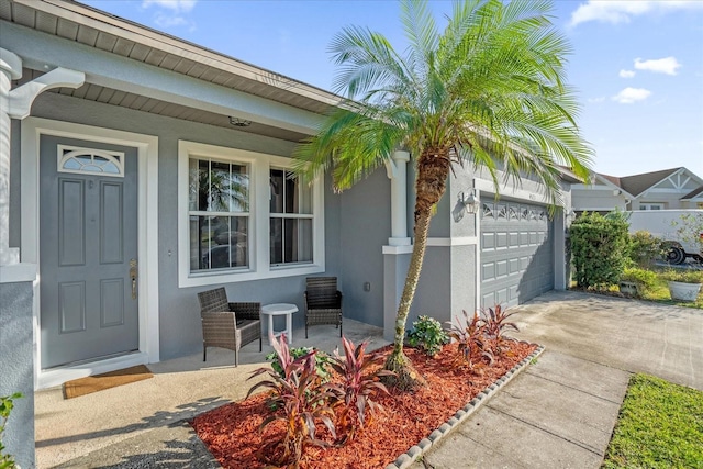 4523 Ashtubula Ct, Orlando, FL 32818 - property entrance with stucco siding, an attached garage, driveway, and covered porch