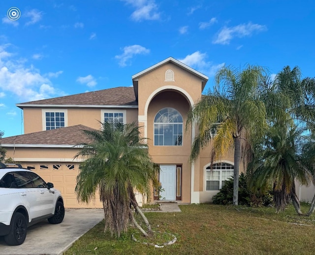 view of front of property with a front yard and a garage