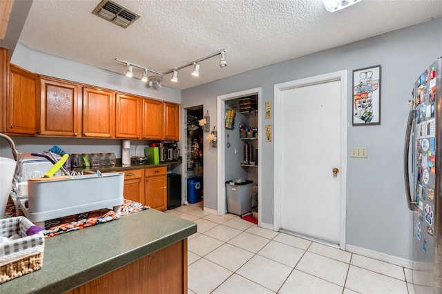 kitchen with light tile patterned flooring and a textured ceiling