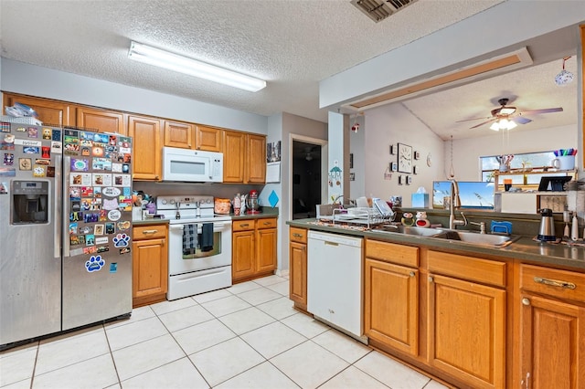 kitchen with a textured ceiling, white appliances, ceiling fan, sink, and light tile patterned floors